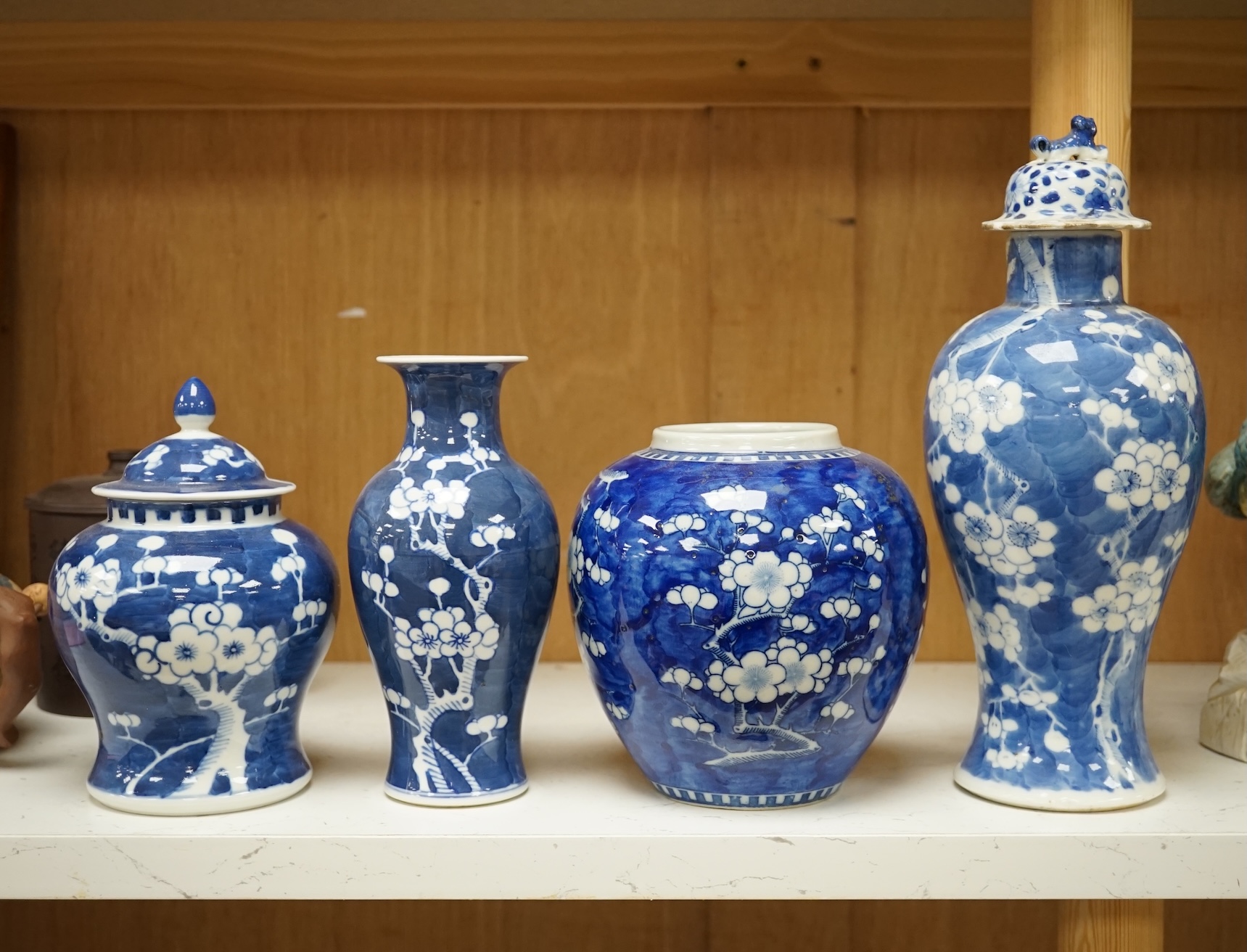 Two Chinese prunus jars and two vases, early 20th century, tallest 26cm, together with two Chinese Yixing pottery teapots, one Republic period, tallest 12.5cm. Condition - varies, poor to fair